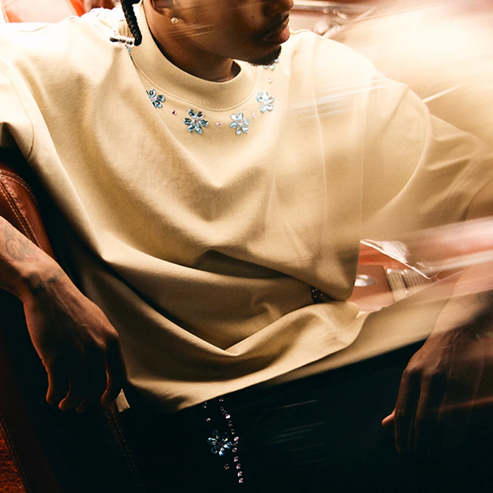 Model in an oversized cream Valabasas tee with a jewelled neckline